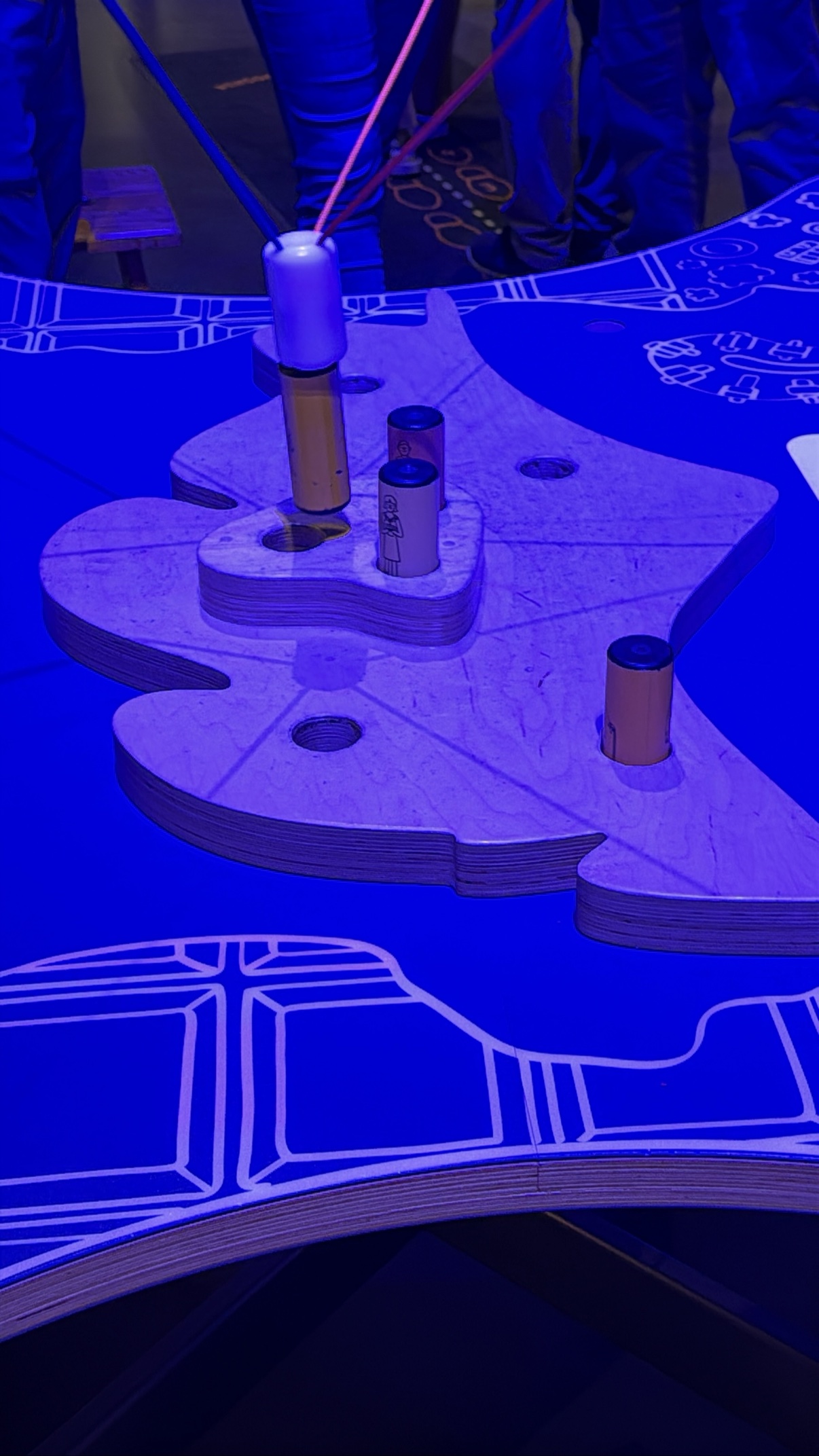 A hands-on exhibit bathed in blue light at the museum